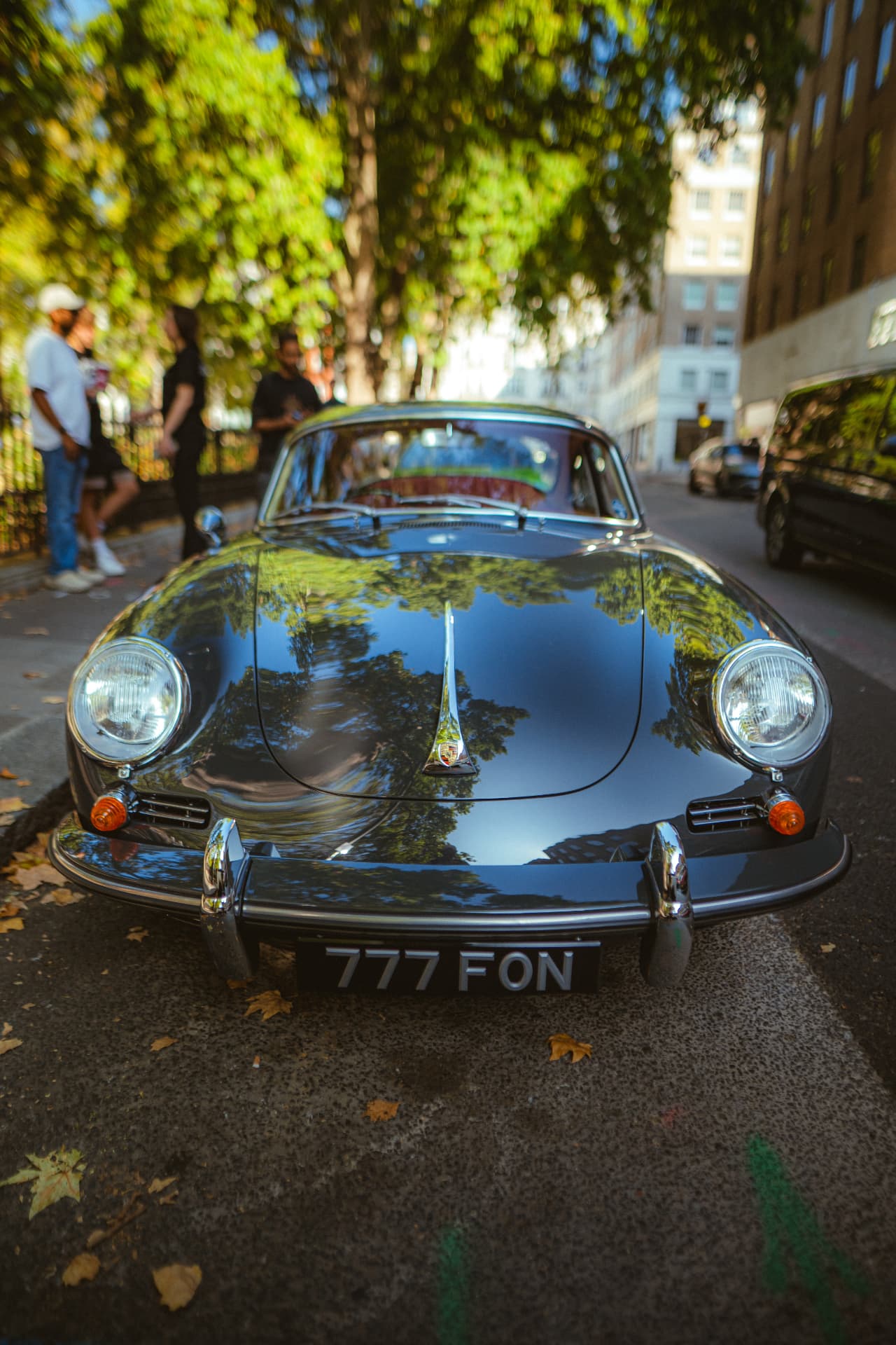 Classic Porsche 356 with guests in the background