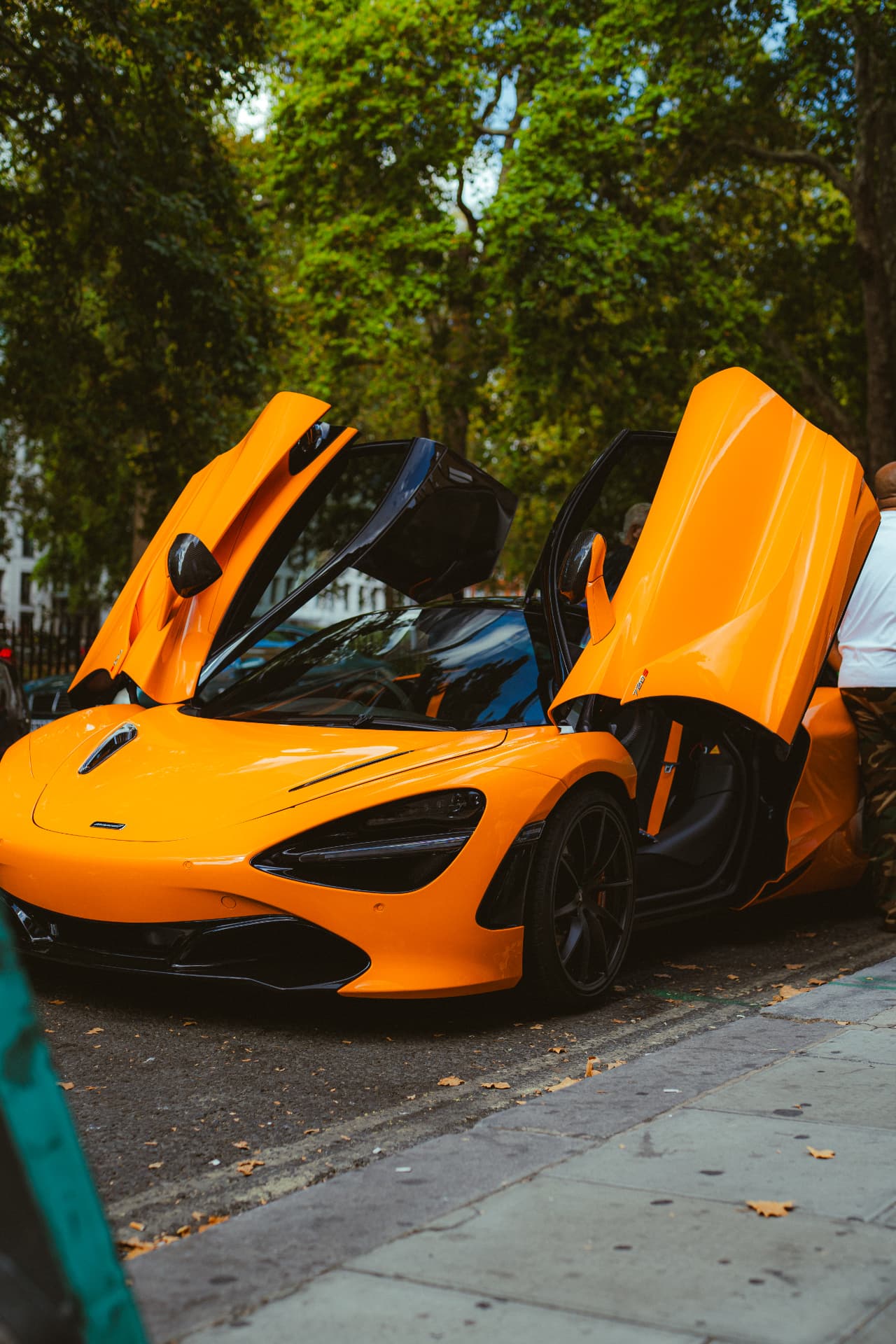 Orange McLaren 720S with doors open in Berkeley Square