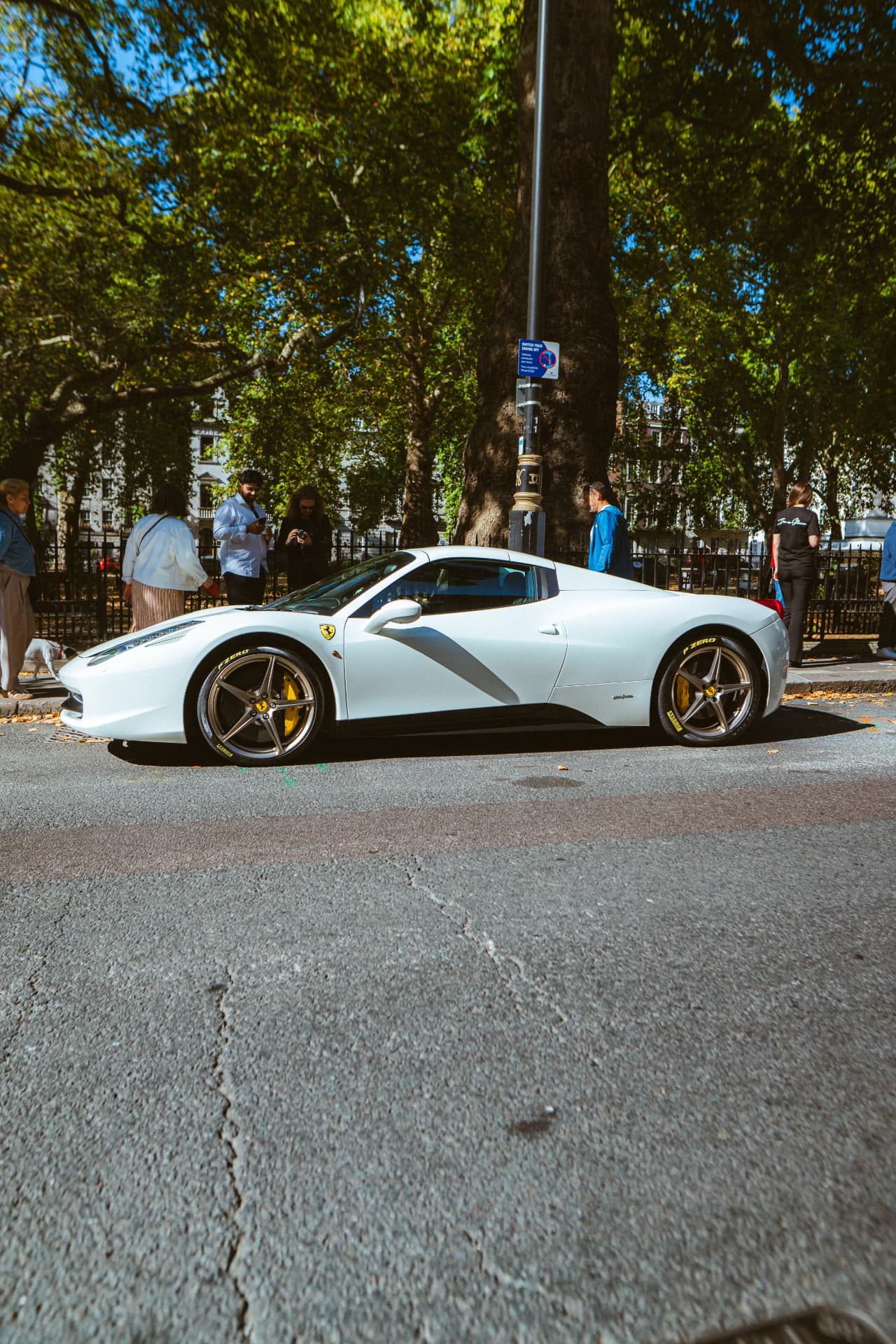 White Ferrari 458 Spider with guests watching in Berkeley Square