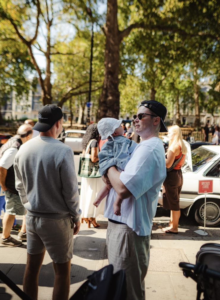 Guests chatting with coffee beneath the trees of Berkeley Square